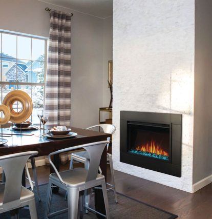 an electric fireplace set into the wall of the dining room in a bright modern home
