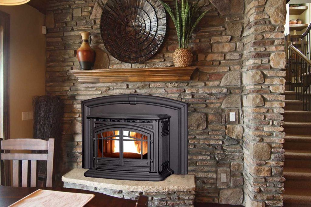 a traditional iron fireplace set into a stone hearth in a rustic home